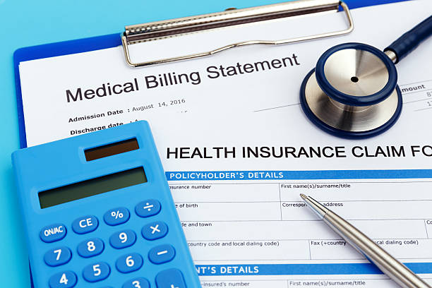 Health insurance claim form with stethoscope and calculator and pen